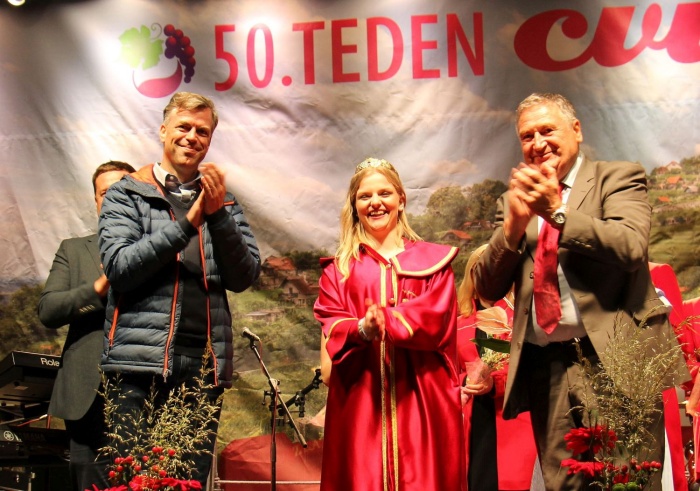 Nasmejana Anja Smerke s krono na glavi, na levi pa novomeški župan Gregor Macedoni in na desni Miran Jurak, predsednik Zveze vinogradnikov Dolenjske.