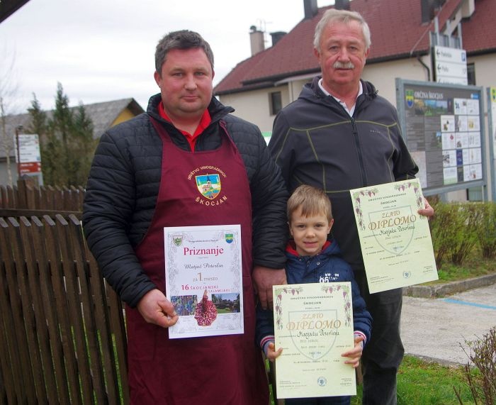 Dvojni zmagovalec Matjaž Peterlin z očetom Janezom in sinom Anžetom, ki sta mu pomagala držati vsa prejeta priznanja.